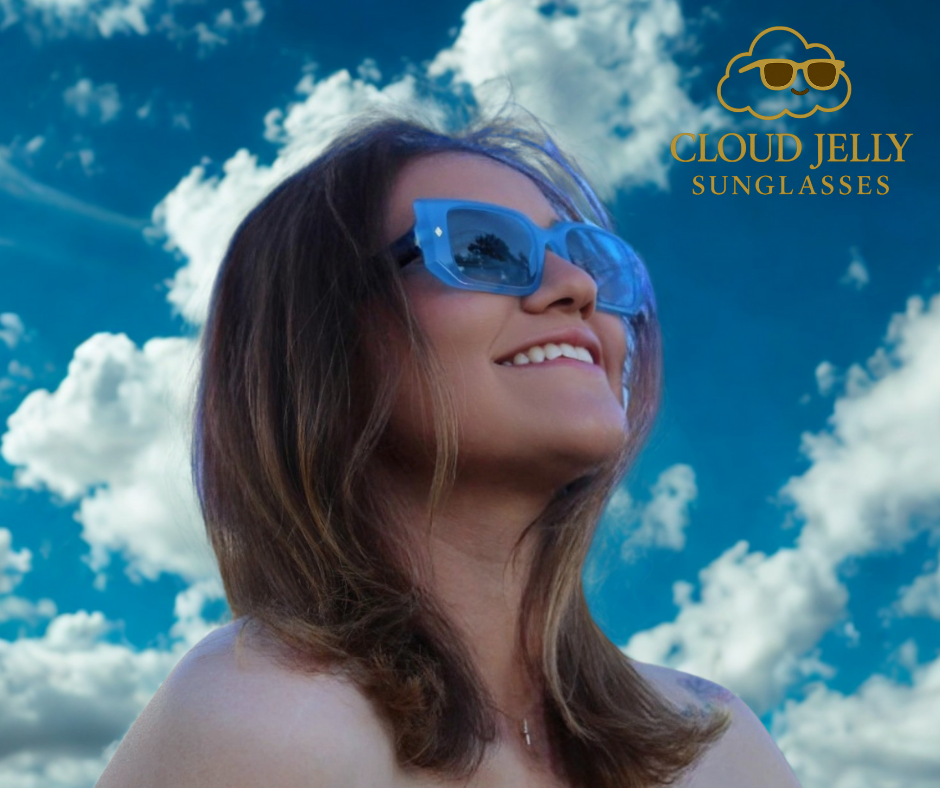 “Model wearing Cloud Jelly River sunglasses with bold blue jelly frame, smiling under clear blue sky”